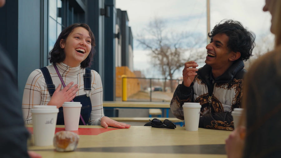 two friends laughing over coffee